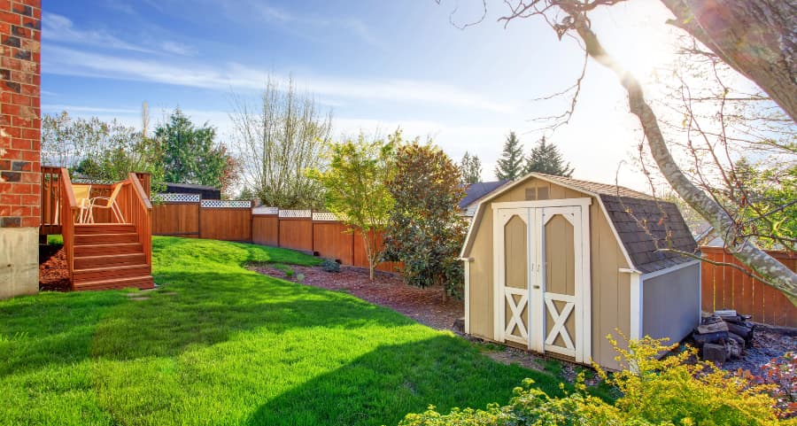 Fenced backyard with storage shed in Bloomington